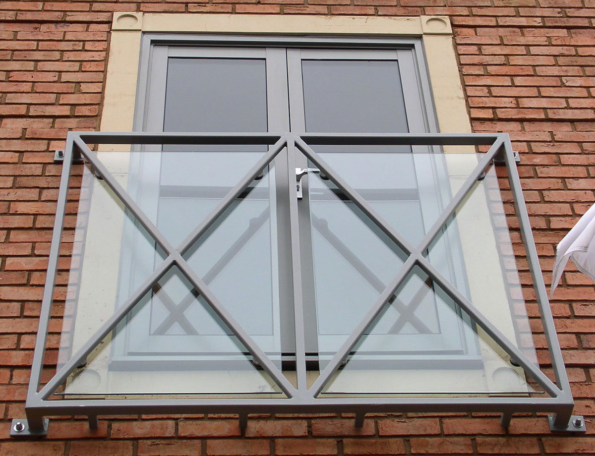 A glass balcony with steel infills